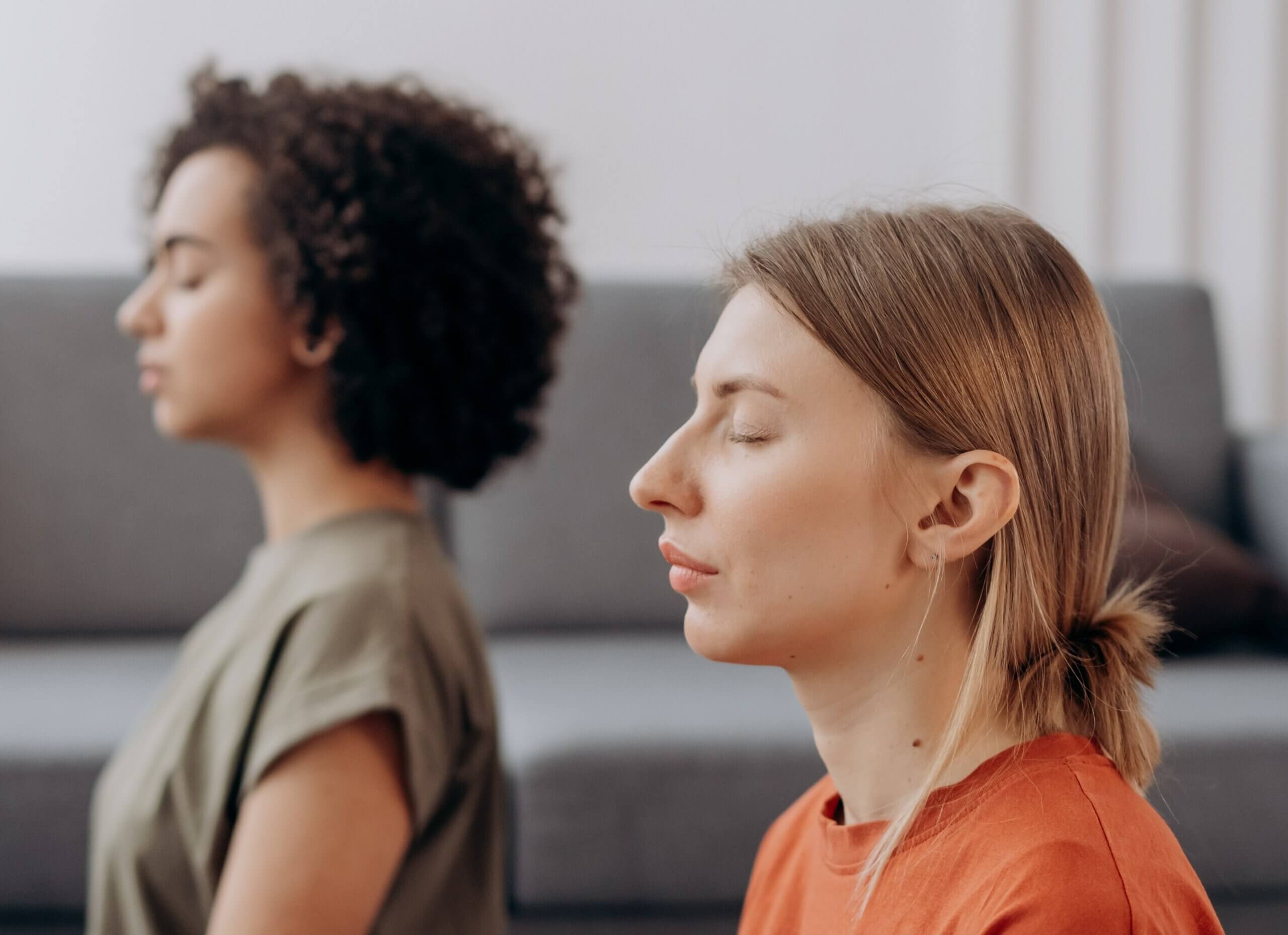 Deux femmes les yeux fermés, en pleine séance de sophrologie
